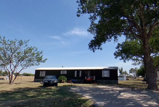 Single-wide mobile home rental with front porch at Stoney Acres, Ponder, TX